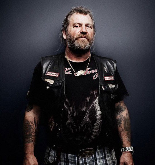 Bearded biker wearing black leather vest with patches – Biker Vest US